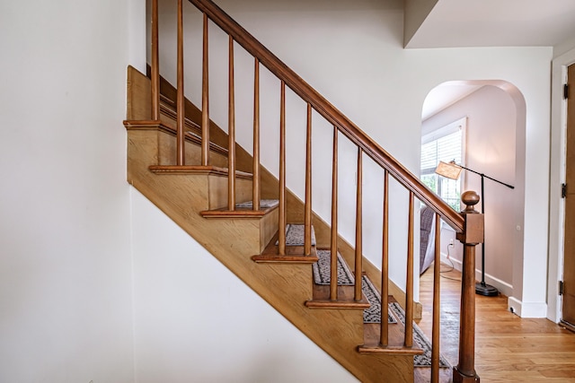 29 Harding St, Biddeford, ME 04005 - staircase with wood finished floors, arched walkways, and baseboards