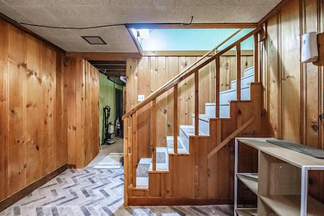 29 Harding St, Biddeford, ME 04005 - stairs featuring wood walls, brick patterned flooring, and baseboards