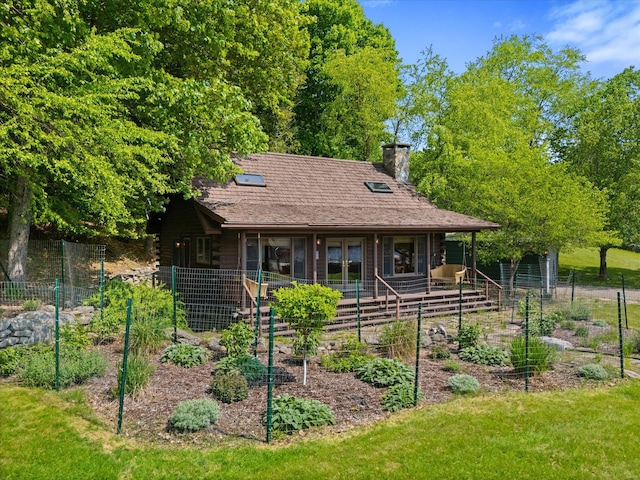 41 Canal St, Grand Lake Stream Plt, ME 04668 - view of front of house featuring a vegetable garden and a chimney