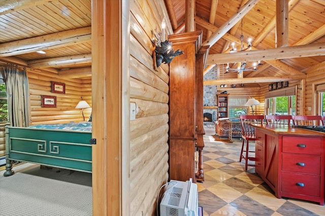 41 Canal St, Grand Lake Stream Plt, ME 04668 - kitchen with wooden ceiling with exposed beams, log walls, and a fireplace