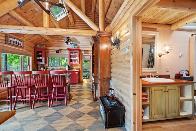 41 Canal St, Grand Lake Stream Plt, ME 04668 - dining space featuring wood ceiling with exposed beams, rustic walls, tile patterned floors, and high vaulted ceiling