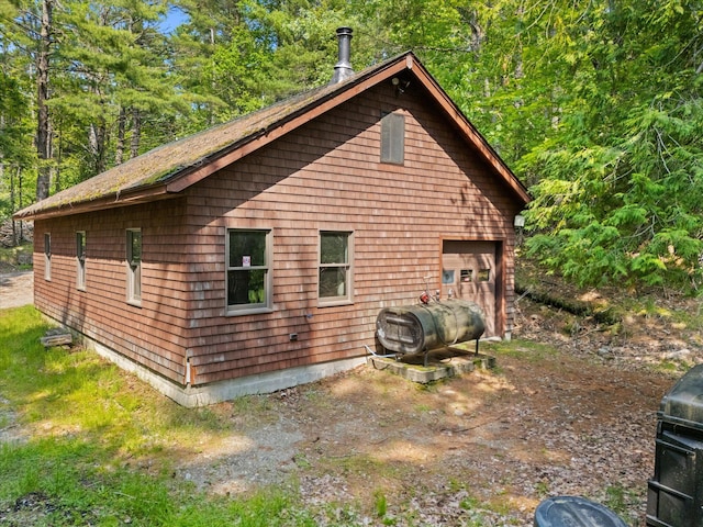 41 Canal St, Grand Lake Stream Plt, ME 04668 - view of home's exterior with oil tank and a garage
