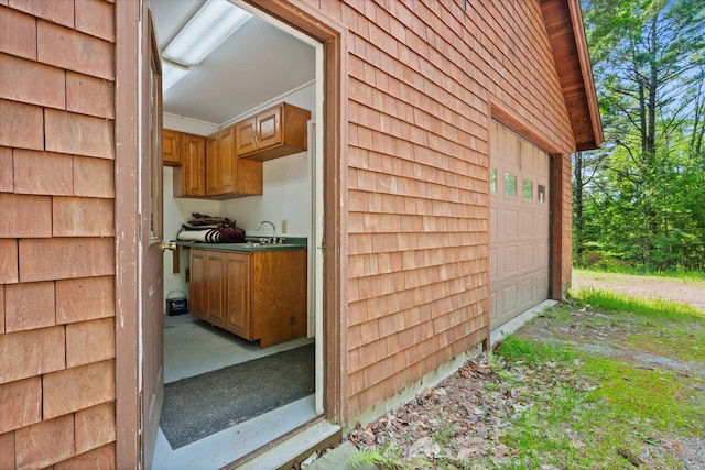 41 Canal St, Grand Lake Stream Plt, ME 04668 - view of side of property with a garage, a sink, and dirt driveway