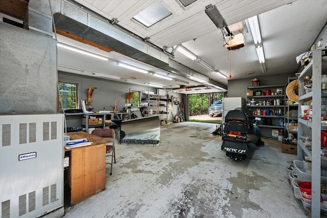 41 Canal St, Grand Lake Stream Plt, ME 04668 - garage featuring a workshop area and a garage door opener