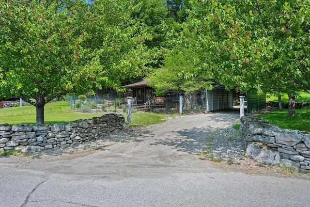 41 Canal St, Grand Lake Stream Plt, ME 04668 - view of property hidden behind natural elements with asphalt driveway, a front yard, and a carport