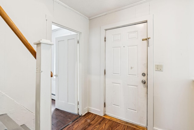 13-15 James St, Auburn, ME 04210 - foyer entrance featuring wood finished floors, crown molding, a baseboard heating unit, and stairway