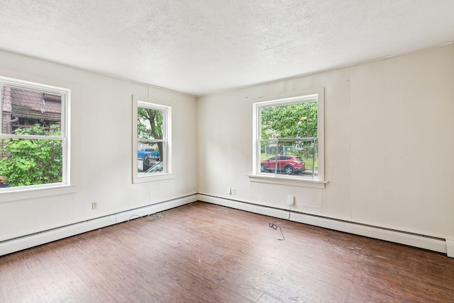 13-15 James St, Auburn, ME 04210 - unfurnished room featuring wood finished floors, a textured ceiling, and a baseboard radiator