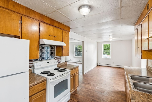 13-15 James St, Auburn, ME 04210 - kitchen with white appliances, under cabinet range hood, a paneled ceiling, baseboard heating, and dark wood-style floors