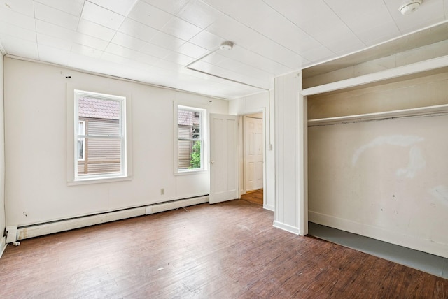13-15 James St, Auburn, ME 04210 - unfurnished bedroom with a baseboard heating unit, wood finished floors, and a closet