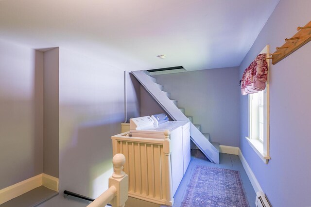 86 High St, Belfast, ME 04915 - stairway with washer and clothes dryer, a baseboard heating unit, and baseboards