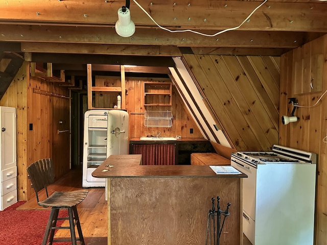 267 Tufts Pond Rd, Kingfield, ME 04947 - kitchen featuring white range, wooden walls, a center island, and wood-type flooring