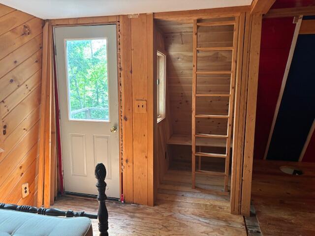 267 Tufts Pond Rd, Kingfield, ME 04947 - entryway with wood walls and hardwood / wood-style floors