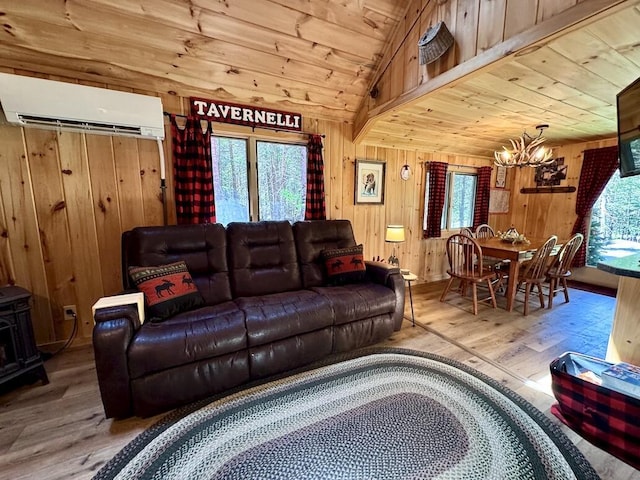 133 Camp Waya-Awi Rd, Rangeley, ME 04970 - living room with a wall unit AC, a chandelier, wood finished floors, wooden walls, and wooden ceiling