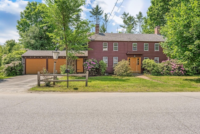 16 Old Village Rd, Winthrop, ME 04364 - view of front of home featuring a chimney, a front lawn, asphalt driveway, and an attached garage