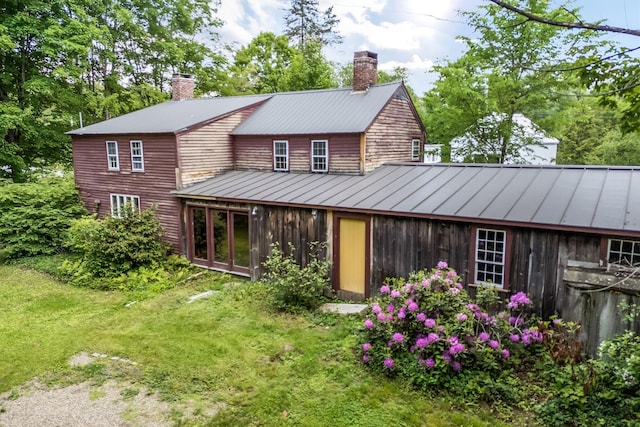 16 Old Village Rd, Winthrop, ME 04364 - rear view of property featuring a standing seam roof, a chimney, a metal roof, and a lawn