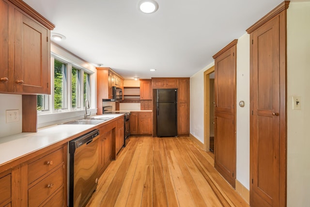 16 Old Village Rd, Winthrop, ME 04364 - kitchen featuring black appliances, light wood finished floors, recessed lighting, and brown cabinetry
