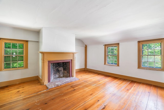 16 Old Village Rd, Winthrop, ME 04364 - unfurnished living room with a fireplace with raised hearth, hardwood / wood-style floors, and vaulted ceiling