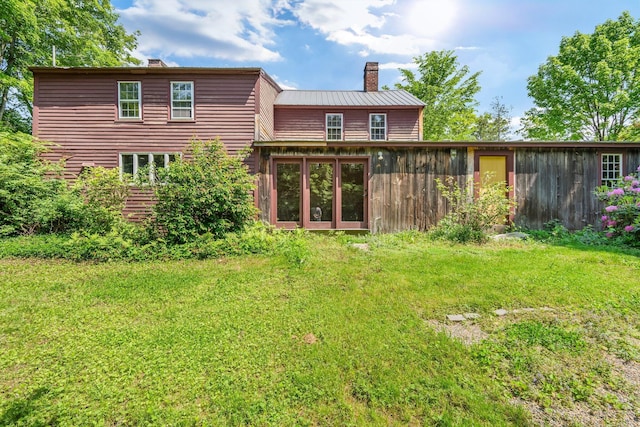 16 Old Village Rd, Winthrop, ME 04364 - rear view of property with a chimney, a lawn, and a metal roof