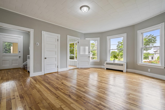 2 Stobie St, Winslow, ME 04901 - unfurnished room with radiator, light wood-style flooring, crown molding, and plenty of natural light