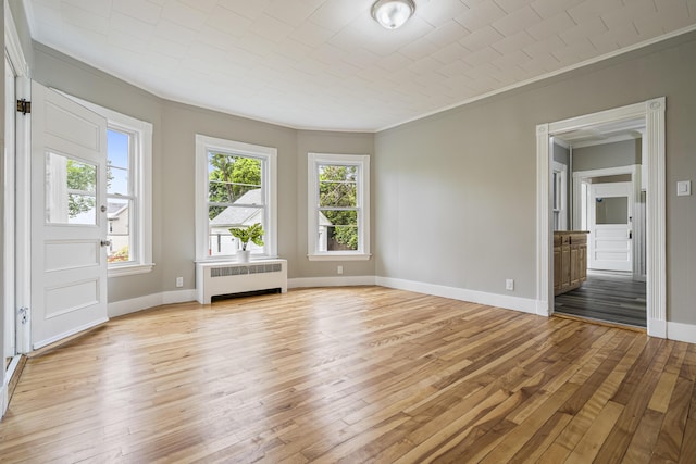 2 Stobie St, Winslow, ME 04901 - spare room with radiator heating unit, crown molding, and light wood-type flooring