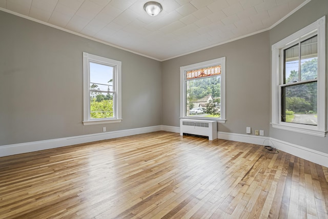 2 Stobie St, Winslow, ME 04901 - spare room featuring radiator heating unit, ornamental molding, and light wood-style floors
