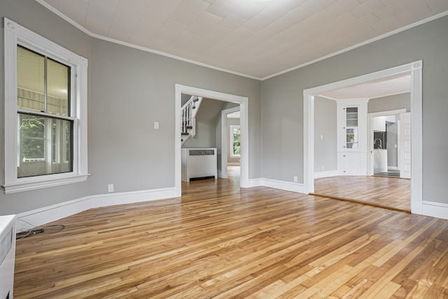 2 Stobie St, Winslow, ME 04901 - unfurnished room featuring light wood-style flooring, crown molding, and radiator heating unit