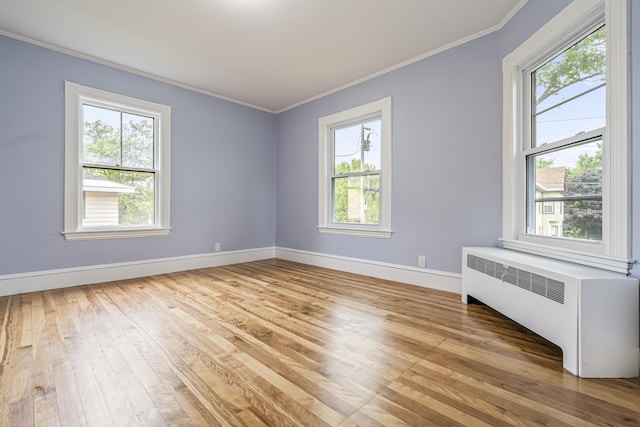 2 Stobie St, Winslow, ME 04901 - unfurnished room with radiator, light wood finished floors, and crown molding
