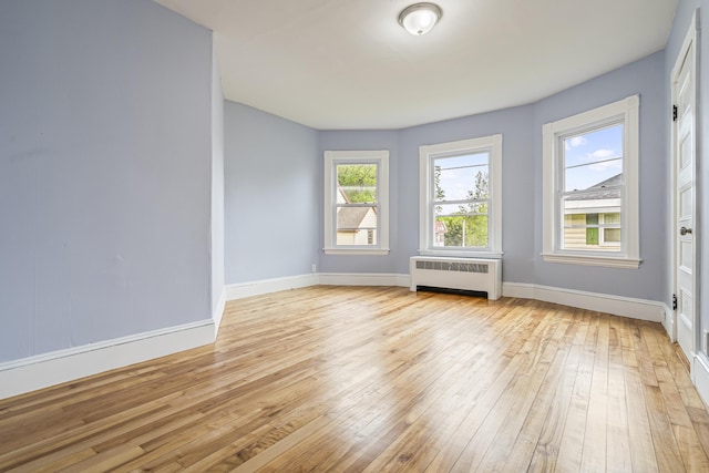 2 Stobie St, Winslow, ME 04901 - empty room featuring radiator and light wood-type flooring