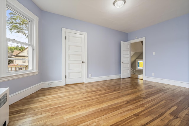 2 Stobie St, Winslow, ME 04901 - unfurnished bedroom featuring hardwood / wood-style floors, multiple windows, and a closet