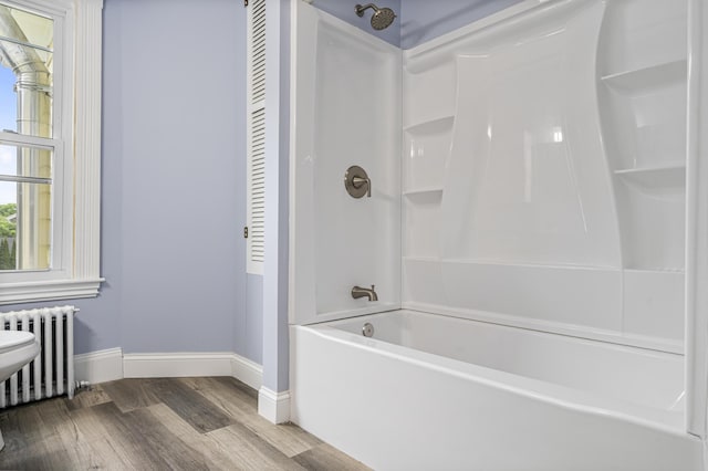 2 Stobie St, Winslow, ME 04901 - bathroom featuring radiator heating unit, wood finished floors, and shower / washtub combination