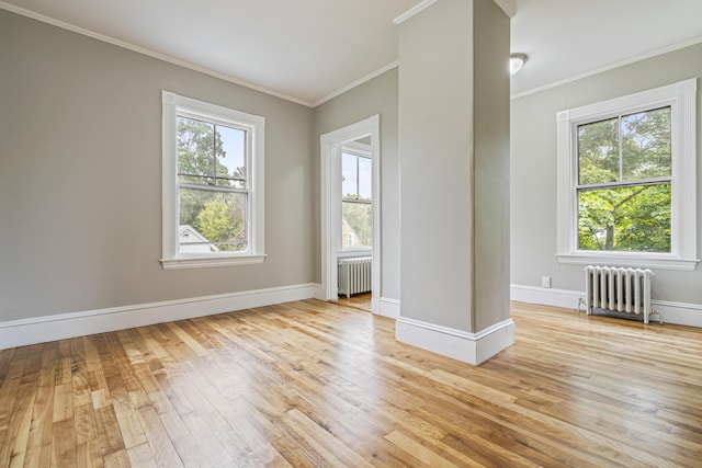 2 Stobie St, Winslow, ME 04901 - empty room featuring radiator, light wood finished floors, and ornamental molding