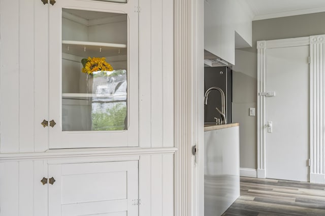 2 Stobie St, Winslow, ME 04901 - laundry area with ornamental molding and wood finished floors