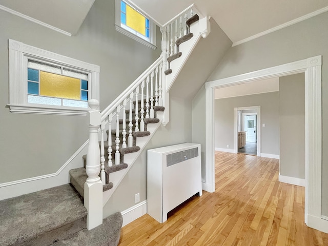 2 Stobie St, Winslow, ME 04901 - stairway with radiator, wood finished floors, plenty of natural light, and ornamental molding
