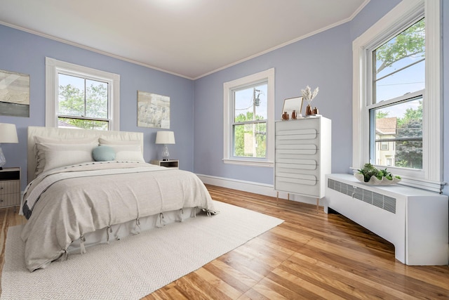 2 Stobie St, Winslow, ME 04901 - bedroom featuring radiator, light wood-style floors, and ornamental molding