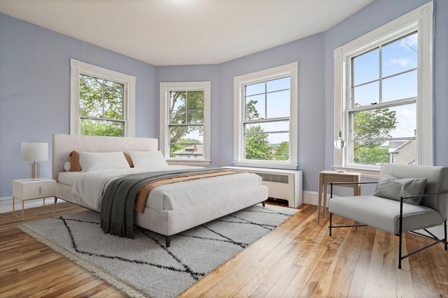 2 Stobie St, Winslow, ME 04901 - bedroom featuring radiator, multiple windows, and wood finished floors