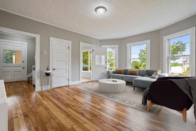 2 Stobie St, Winslow, ME 04901 - living area with light wood finished floors, ornamental molding, and plenty of natural light