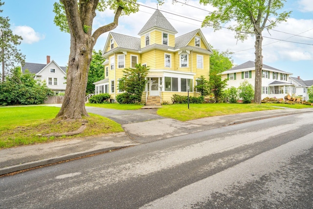 2 Stobie St, Winslow, ME 04901 - victorian home featuring a front lawn and driveway