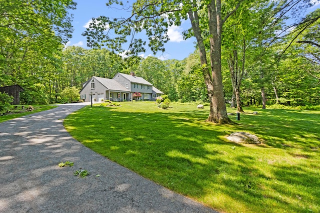 6 Hackmatack Dr, Scarborough, ME 04074 - view of front of property featuring a garage, a chimney, asphalt driveway, and a front lawn