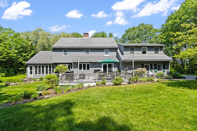 6 Hackmatack Dr, Scarborough, ME 04074 - back of property with a chimney, a yard, a wooden deck, and a shingled roof