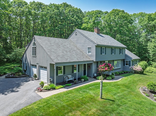 6 Hackmatack Dr, Scarborough, ME 04074 - colonial home with asphalt driveway, a garage, a chimney, a shingled roof, and a front lawn