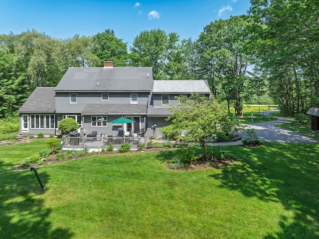 6 Hackmatack Dr, Scarborough, ME 04074 - back of house featuring a chimney, a lawn, a shingled roof, and a sunroom