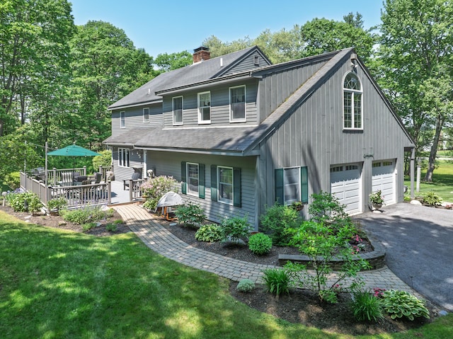 6 Hackmatack Dr, Scarborough, ME 04074 - view of front of house with driveway, a front yard, a garage, a deck, and roof with shingles