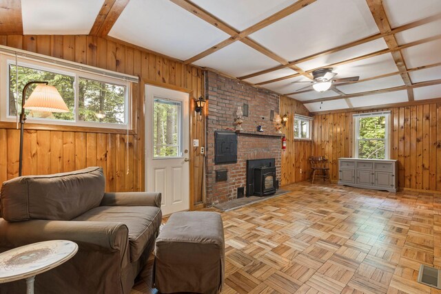 60 Watson Hill Rd, Limerick, ME 04048 - living area featuring wood walls, a wood stove, ceiling fan, and coffered ceiling