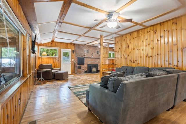 60 Watson Hill Rd, Limerick, ME 04048 - living room featuring wood walls, a ceiling fan, vaulted ceiling, wood finished floors, and a wood stove