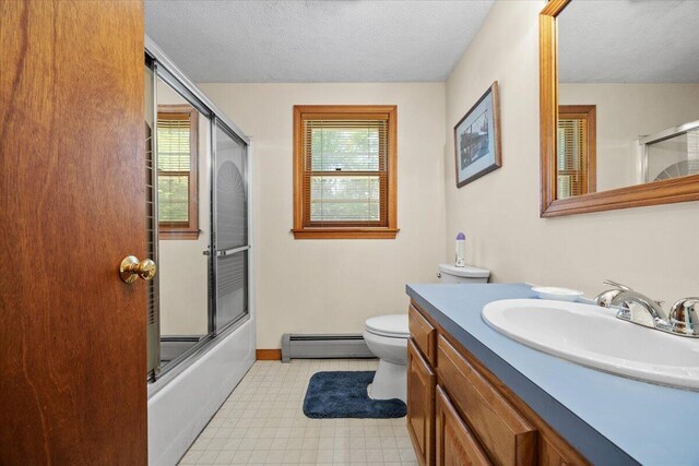 52 Douglas Ave, Saco, ME 04072 - bathroom with a baseboard radiator, vanity, healthy amount of natural light, a textured ceiling, and tile patterned floors