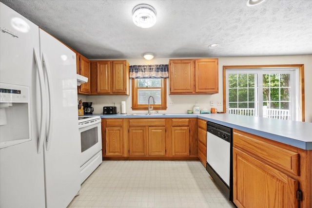52 Douglas Ave, Saco, ME 04072 - kitchen with white appliances, a peninsula, light countertops, a textured ceiling, and light floors