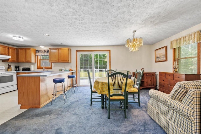 52 Douglas Ave, Saco, ME 04072 - dining area with a chandelier, a textured ceiling, and dark carpet
