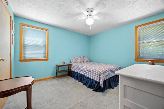 52 Douglas Ave, Saco, ME 04072 - carpeted bedroom featuring a textured ceiling and ceiling fan