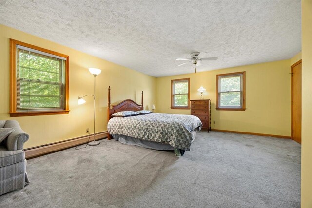 52 Douglas Ave, Saco, ME 04072 - bedroom featuring carpet floors, a baseboard heating unit, a textured ceiling, and a ceiling fan