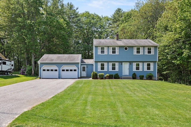 52 Douglas Ave, Saco, ME 04072 - colonial home with an attached garage, driveway, a front lawn, a chimney, and view of wooded area